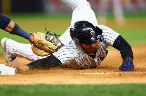 NEW YORK, NEW YORK - OCTOBER 23: Gleyber Torres #25 of the New York Yankees slides back into first base in the third inning against the Houston Astros in game four of the American League Championship Series at Yankee Stadium on October 23, 2022 in the Bronx borough of New York City. (Photo by Elsa/Getty Images)