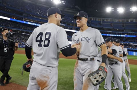 TORONTO, ON - SEPTEMBER 27: Aaron Judge #99 of the New York Yankees high-fives Anthony Rizzo #48 after defeating the Toronto Blue Jays to clinch first place in the American League East after the game at Rogers Centre on on September 27, 2022, in Toronto, Canada. (Photo by New York Yankees/Getty Images)