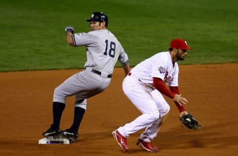 PHILADELPHIA - NOVEMBER 01: Johnny Damon #18 of the New York Yankees steals second base in the top of the ninth inning against Pedro Feliz #7 of the Philadelphia Phillies in Game Four of the 2009 MLB World Series at Citizens Bank Park on November 1, 2009 in Philadelphia, Pennsylvania. Damon advanced to third on the play. (Photo by Chris McGrath/Getty Images)