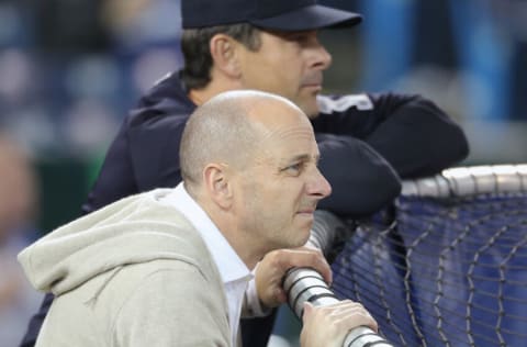 TORONTO, ON - MARCH 30: General manager Brian Cashman of the New York Yankees and manager Aaron Boone #17 look on during batting practice before the start of MLB game action against the Toronto Blue Jays at Rogers Centre on March 30, 2018 in Toronto, Canada. (Photo by Tom Szczerbowski/Getty Images) *** Local Caption *** Aaron Boone;Brian Cashman