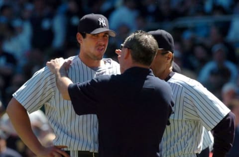 Yankees trainer Gene Monahan checking pitcher Carl Pavano after he was hit in the head by a ball hit by the Orioles Melvin Mora.
Yankees' Carl Pavano