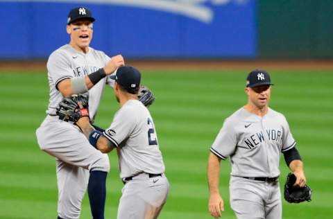 Sep 29, 2020; Cleveland, Ohio, USA; New York Yankees right fielder Aaron Judge (left) and shortstop Gleyber Torres (middle) and left fielder Brett Gardner (right) celebrate after defeating the Cleveland Indians at Progressive Field. Mandatory Credit: David Richard-USA TODAY Sports