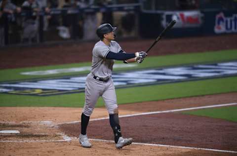 New York Yankees designated hitter Giancarlo Stanton (27) hits a grand slam against the Tampa Bay Rays during the ninth inning in game one of the 2020 ALDS at Petco Park. Mandatory Credit: Orlando Ramirez-USA TODAY Sports