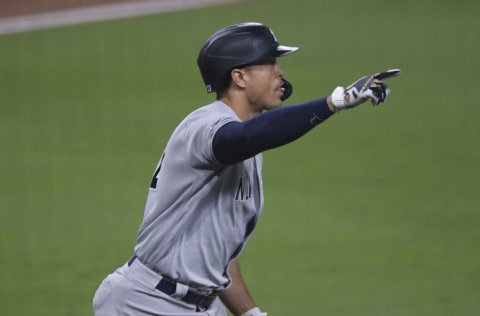 Oct 5, 2020; San Diego, California, USA; New York Yankees designated hitter Giancarlo Stanton (27) hits a grand slam against the Tampa Bay Rays during the ninth inning in game one of the 2020 ALDS at Petco Park. Mandatory Credit: Orlando Ramirez-USA TODAY Sports