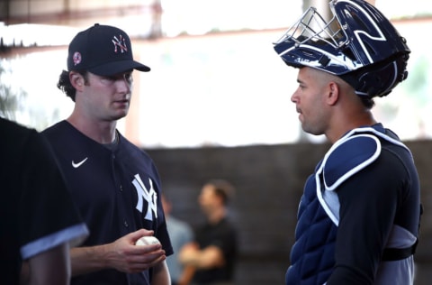 Feb 12, 2020; Tampa, Florida, USA; New York Yankees starting pitcher Gerrit Cole (45) and catcher Gary Sanchez (24) talk as pitchers and catchers report for spring training at George M. Steinbrenner Field. Mandatory Credit: Kim Klement-USA TODAY Sports