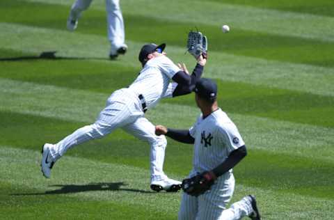 Apr 3, 2021; Bronx, New York, USA; New York Yankees left fielder Clint Frazier (77) misplays a hit by Toronto Blue Jays third baseman Cavan Biggio (not pictured) during the first inning at Yankee Stadium. Mandatory Credit: Brad Penner-USA TODAY Sports