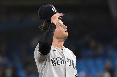 Sep 29, 2021; Toronto, Ontario, CAN; New York Yankees pitcher Gerrit Cole (45) reacts after giving up a double to Toronto Blue Jays shortstop Bo Bichette (not pictured) in the first inning at Rogers Centre. Mandatory Credit: Dan Hamilton-USA TODAY Sports