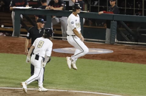 Jun 23, 2021; Omaha, Nebraska, USA; Vanderbilt Commodores utility player Spencer Jones (34) celebrates scoring the winning run with shortstop Carter Young (9) against the Stanford Cardinal at TD Ameritrade Park. Mandatory Credit: Bruce Thorson-USA TODAY Sports