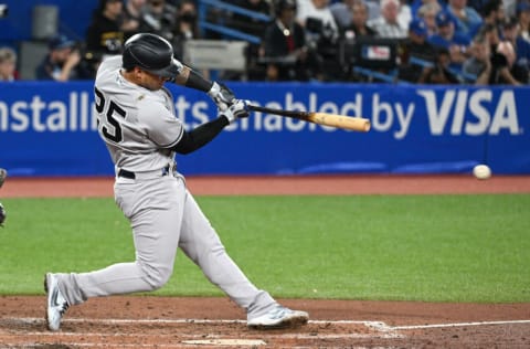 Sep 27, 2022; Toronto, Ontario, CAN; New York Yankees second baeman Gleyber Torres (25) hits an RBI double against the Toronto Blue Jays in the fifth inning at Rogers Centre. Mandatory Credit: Dan Hamilton-USA TODAY Sports