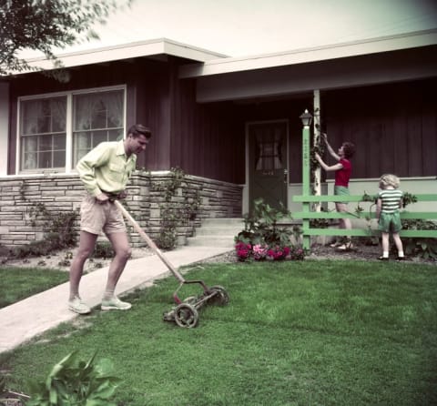 In this photo from the Smithsonian Institution's exhibit, a man mows his lawn in Long Beach, California, in the 1950s.