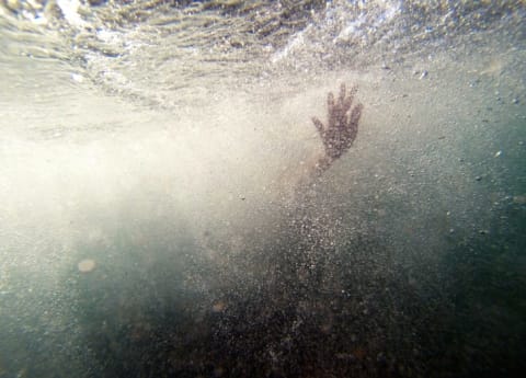 Photo of hand coming out of water