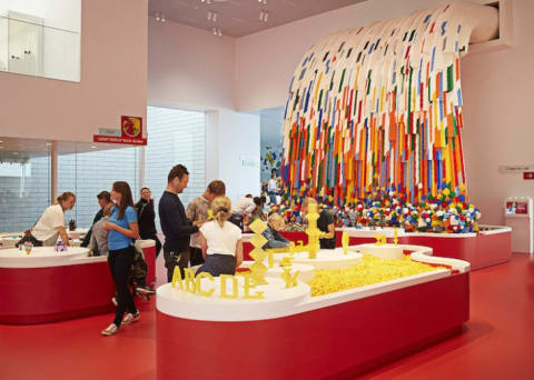 Children play near the Brick Builder Waterfall at the LEGO House in Billund, Denmark.