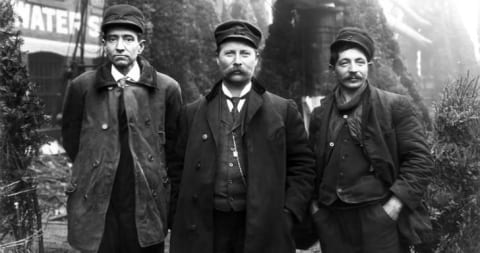 Captain Herman Schuenemann (center) standing with two of his crew members