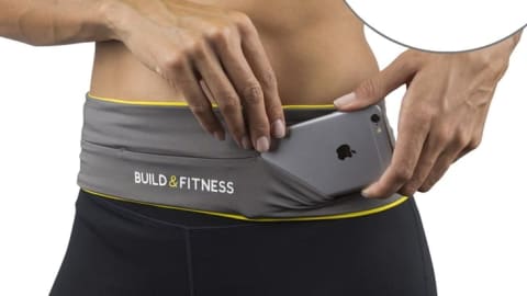 A woman slides an iPhone into her running belt